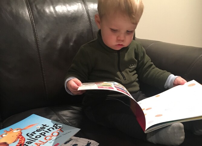 Hannah's wee boy Harvey, enjoying one of the books at home